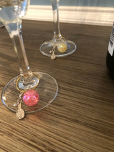 Load image into Gallery viewer, A pink Pickleball Wine Glass Charm on a glass