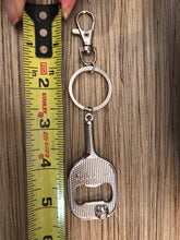 Load image into Gallery viewer, The Pickleball Paddle Bottle Opener and Keychain with a measuring tape showing its length