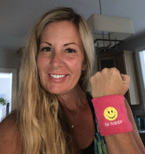 Load image into Gallery viewer, A woman wearing a pink Hit Happy Pickleball Wristband