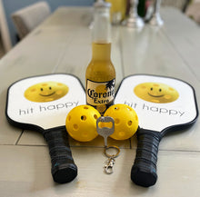Load image into Gallery viewer, Pickleball Paddle Bottle Opener and Keychain with a bottle, paddles, and balls