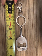 Load image into Gallery viewer, The Pickleball Paddle Bottle Opener and Keychain with a measuring tape showing its length
